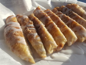 Glazed cinnamon sugar sticks on a tray